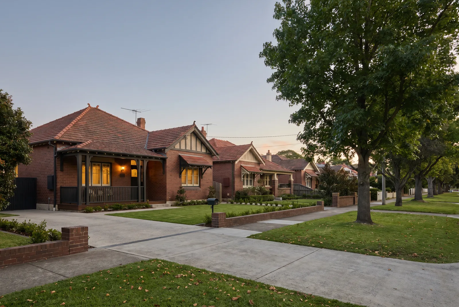 A flat, wide Cammeray street of freestanding brick houses with level driveways